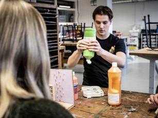 Student Onderwijsassistent met verf in lokaal